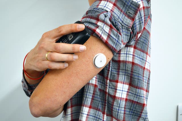The wearable monitor fits on the back of an arm and can be checked via an app (Diabetes UK/PA)