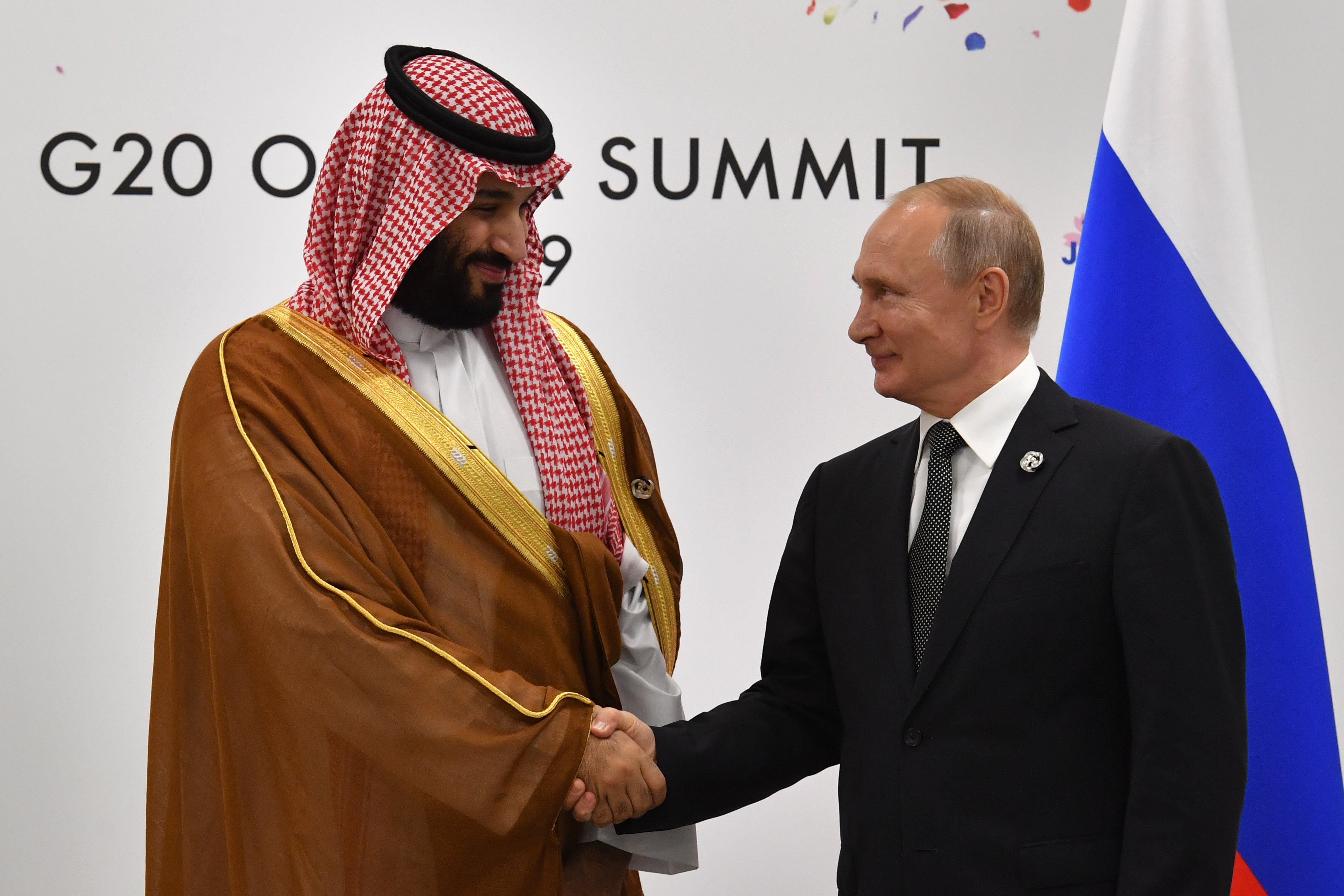 Russian president Vladimir Putin (R) shakes hands with Saudi Arabia’s Crown Prince Mohammed bin Salman during a meeting on the sidelines of the G20 summit in Osaka, 29 June 2019