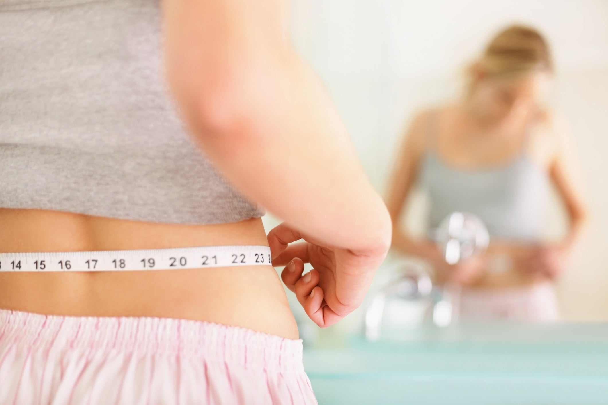 Overweight Woman With Tape Measure Around Waist. Woman Belly Fat