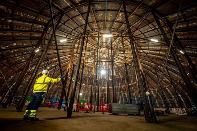 A construction worker stands inside a welded steel dome that will be lifted and placed on top of the nuclear island, which houses the reactor, at Hinkley Point C nuclear power plant near Bridgwater in Somerset (Ben Birchall/PA)