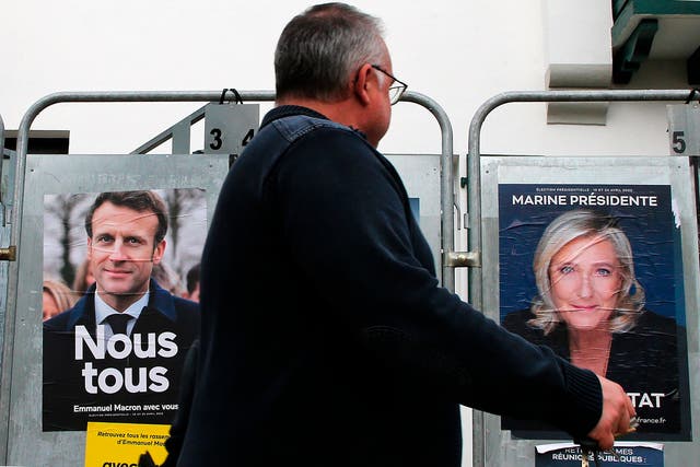 <p>Election posters of French president Emmanuel Macron and his main competitor, Marine Le Pen</p>