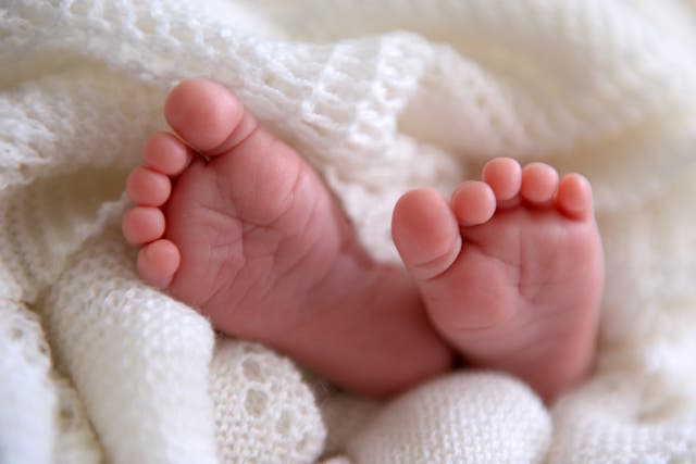 File photo dated 11/07/14 of a new born baby’s feet, as two trusts come under fire for asking for midwives to promote normal birth (PA)