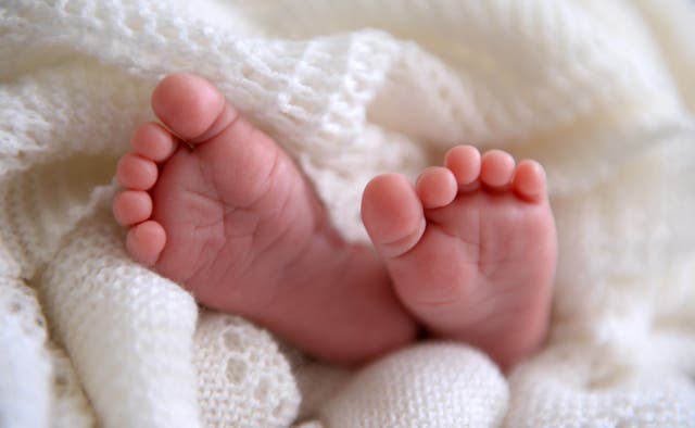 File photo dated 11/07/14 of a new born baby’s feet, as two trusts come under fire for asking for midwives to promote normal birth (PA)