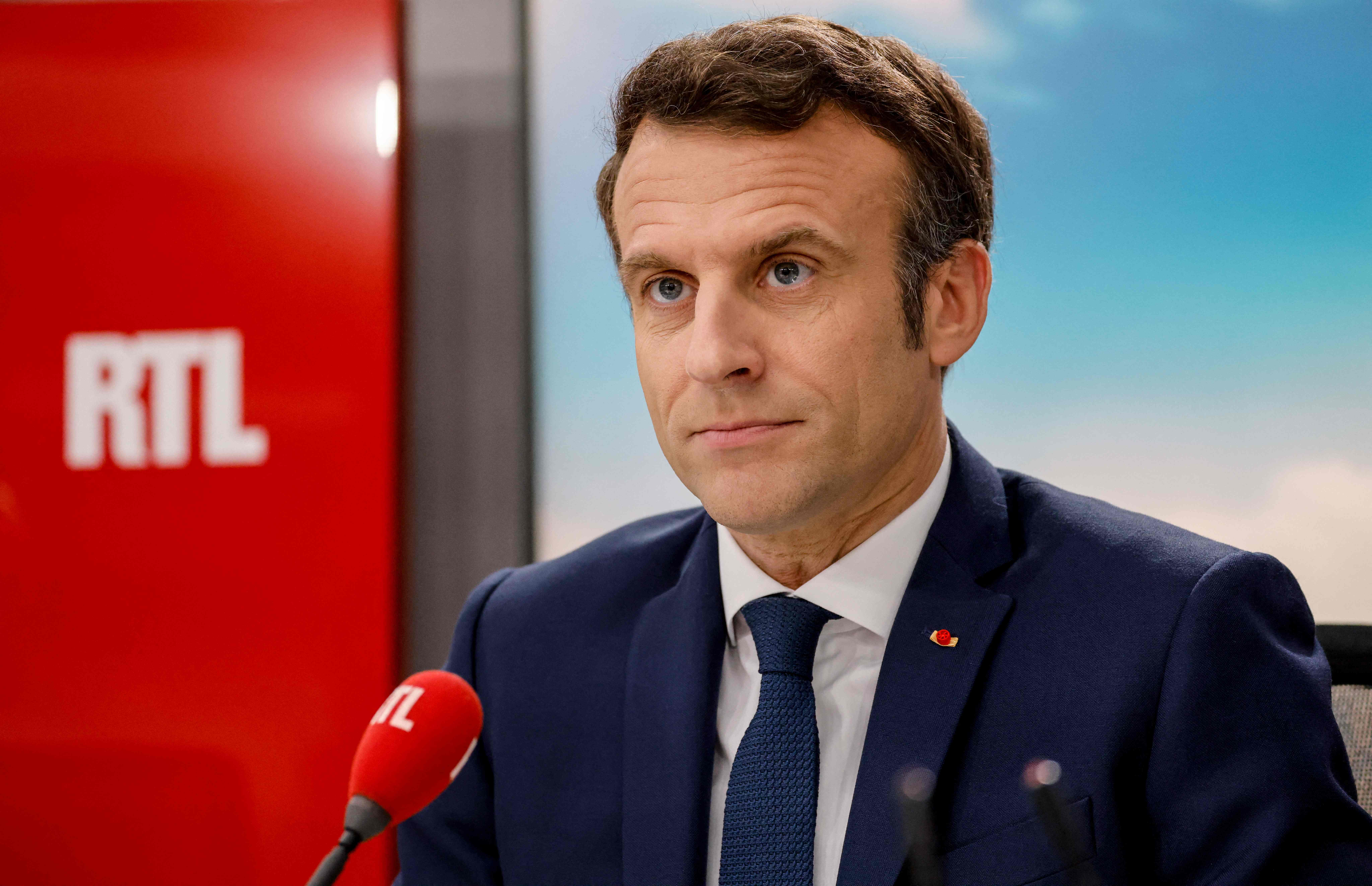 Macron poses before a live interview in the studio of French private radio station RTL in Neuilly-sur-Seine, 8 April 2022