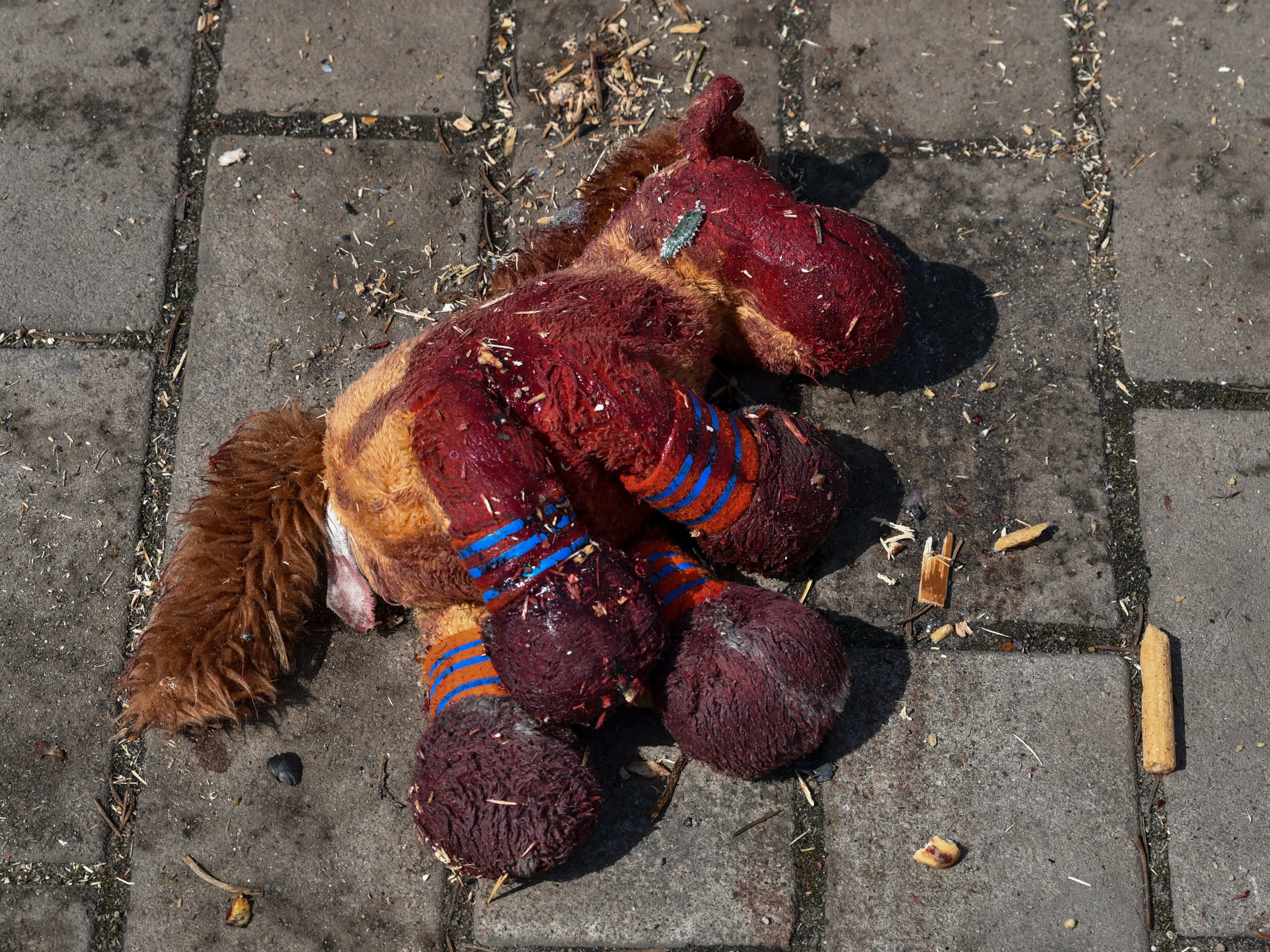 A stuffed horse with bloodstains on it lies on a platform after Russian shelling at the railway station in Kramatorsk