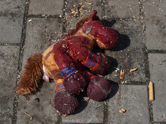 <p>A stuffed horse with bloodstains on it lies on a platform after Russian shelling at the railway station in Kramatorsk</p>