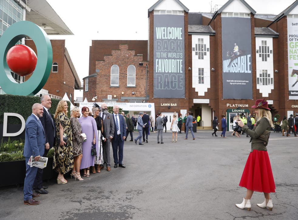 Racegoers have a picture taken during Grand National Day at Aintree Racecourse, Liverpool (Steven Paston/PA)