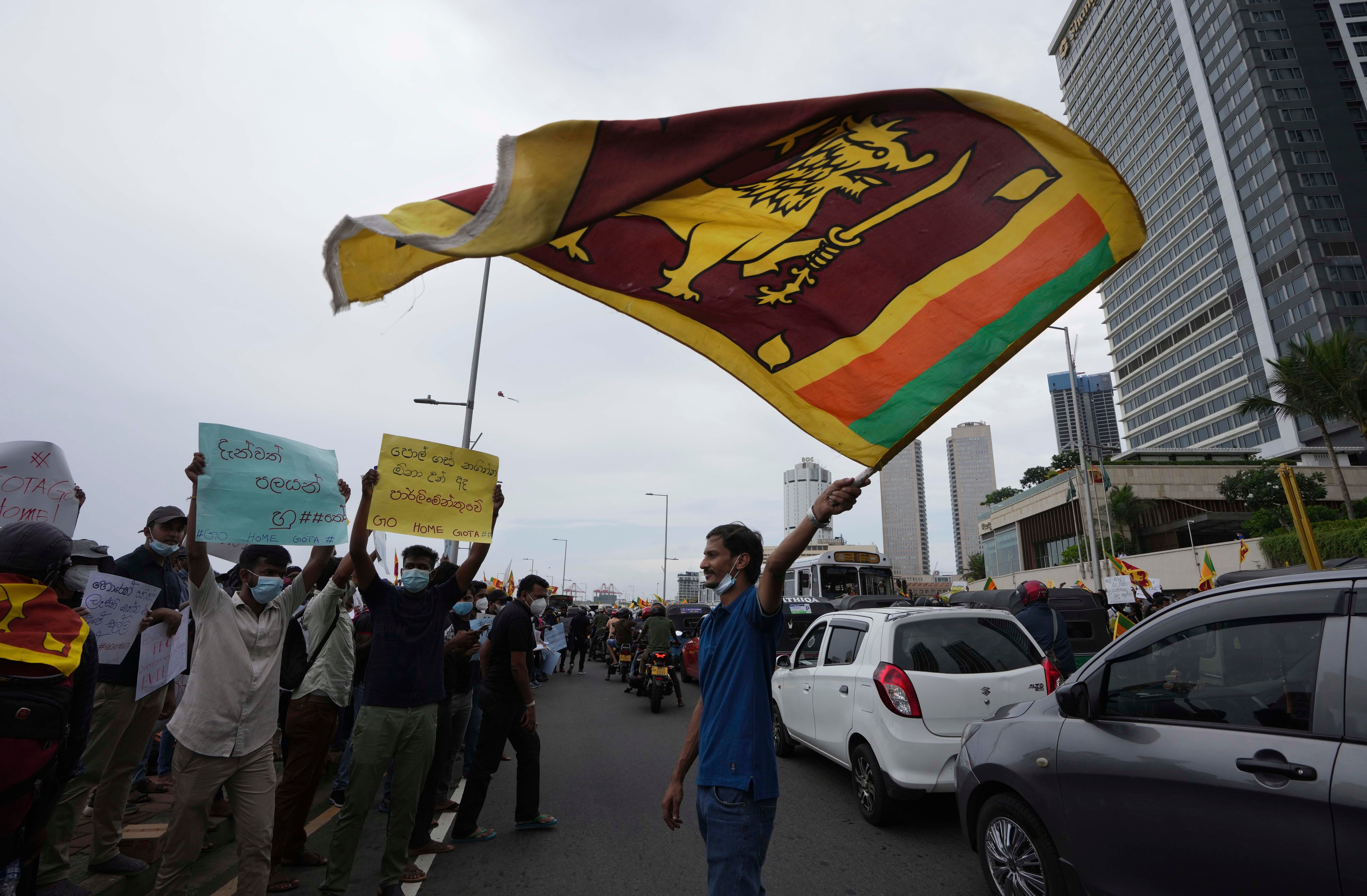 <p>Sri Lankans protest demanding the resignation of president Gotabaya Rajapaksa and his government in Colombo on 9 April</p>