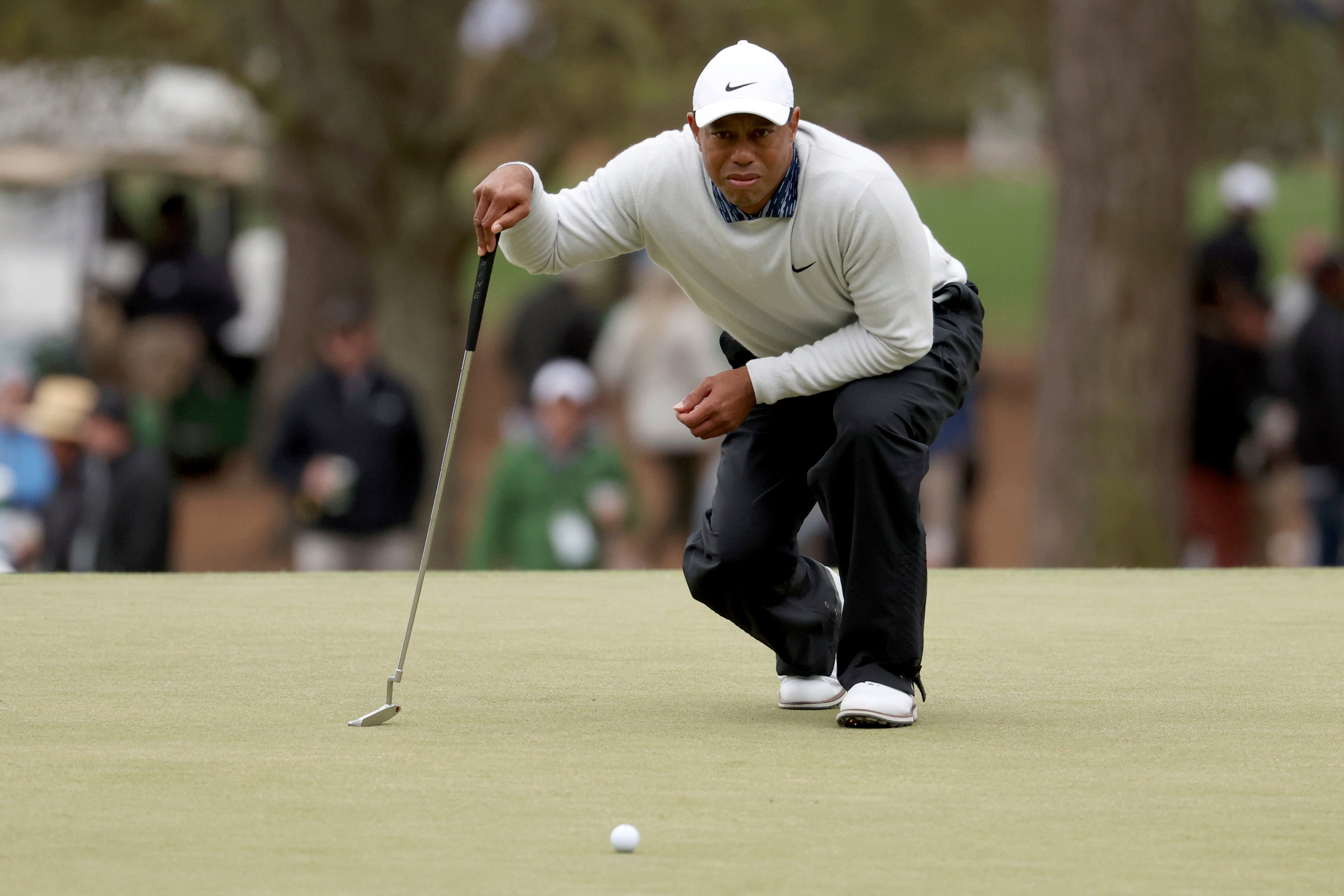 Tiger Woods prepares to putt on the third green during the third round of the Masters (Jason Getz/Atlanta Journal-Constitution via AP)