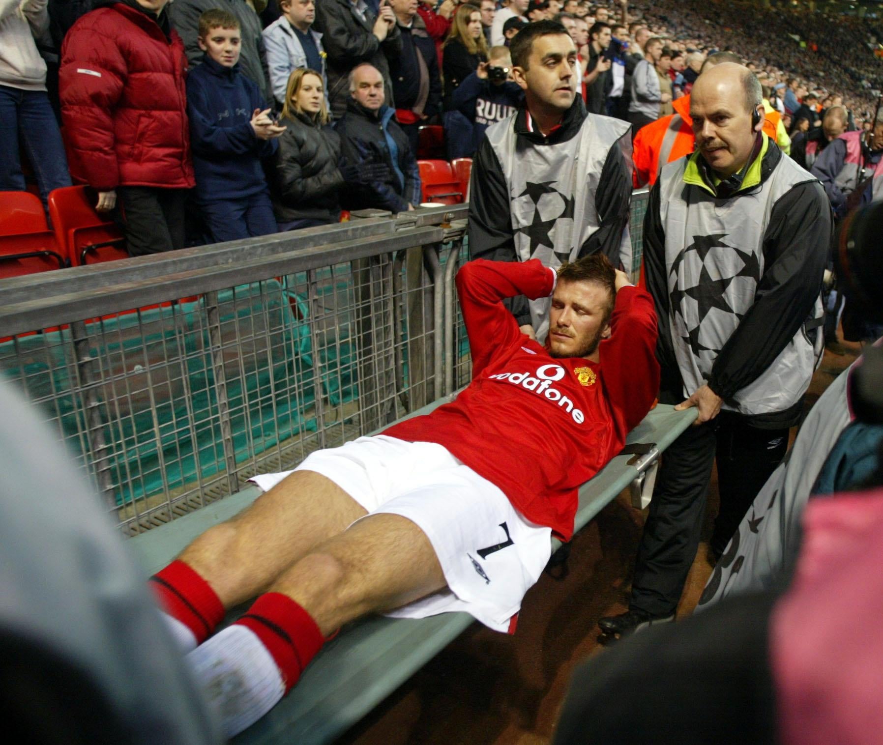David Beckham was carried off after suffering a broken metatarsal on this day in 2002 (Martin Rickett/PA)