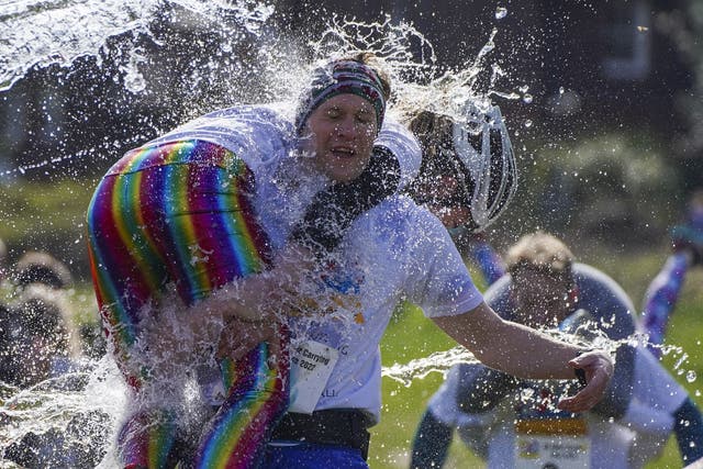Competitors take part in the annual UK Wife Carrying Race (Steve Parsons/PA)