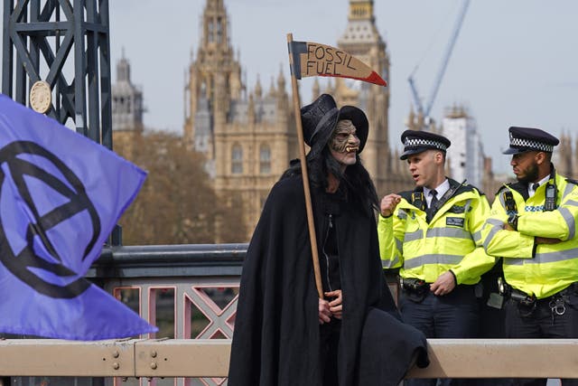 Activists from Extinction Rebellion blocking Lambeth Bridge in central London (Yui Mok/PA)