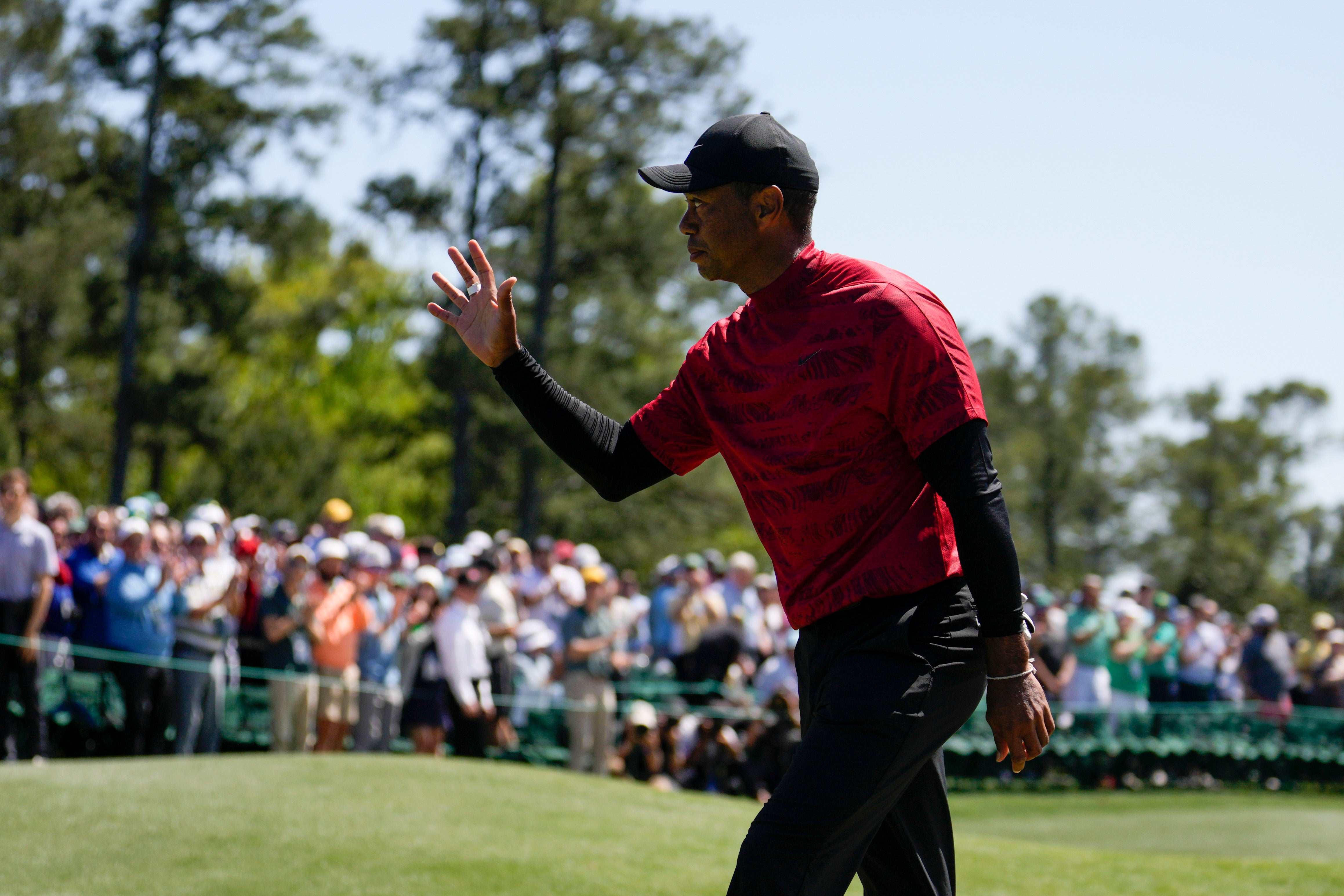 Tiger Woods waves to spectators on the 18th green after his final round at the Masters (Jae C. Hong/AP)