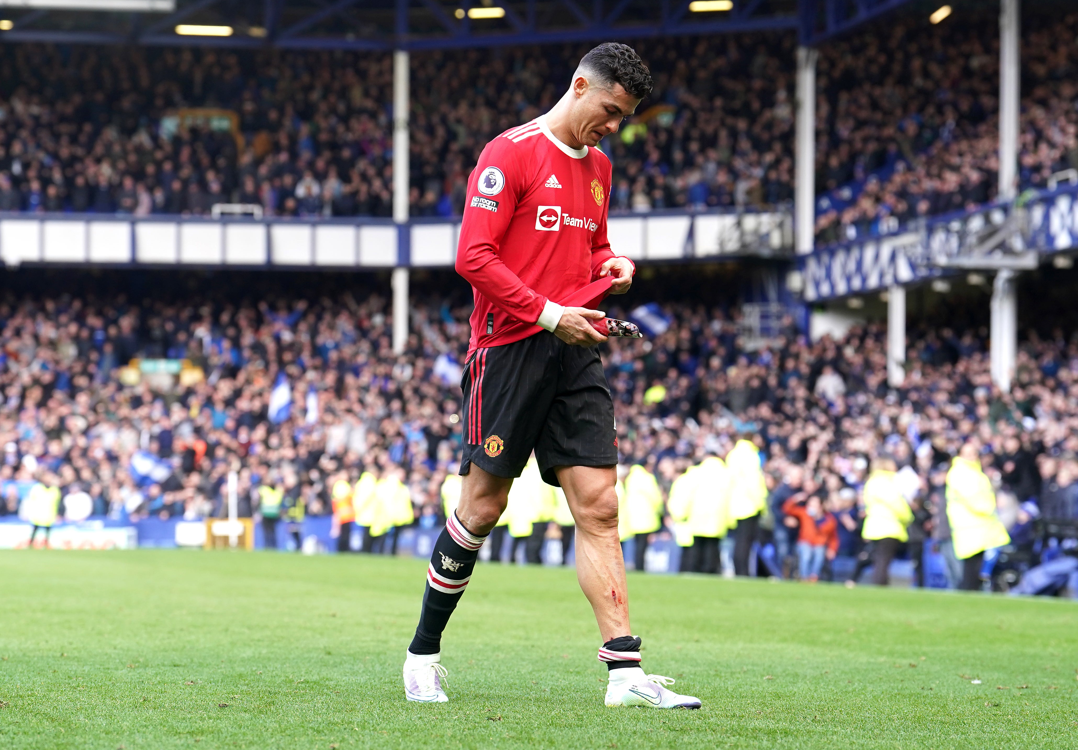 Cristiano Ronaldo assesses a cut on his shin after Manchester United’s 1-0 defeat at Premier League relegation battlers Everton (Martin Rickett/PA)