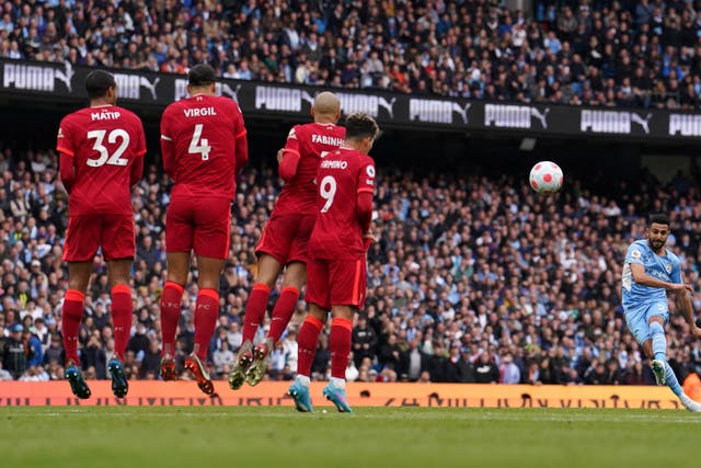 Manchester City’s Riyad Mahrez takes a free-kick that hits a post in Sunday’s Premier League clash with title rivals Liverpool (Martin Rickett/PA)