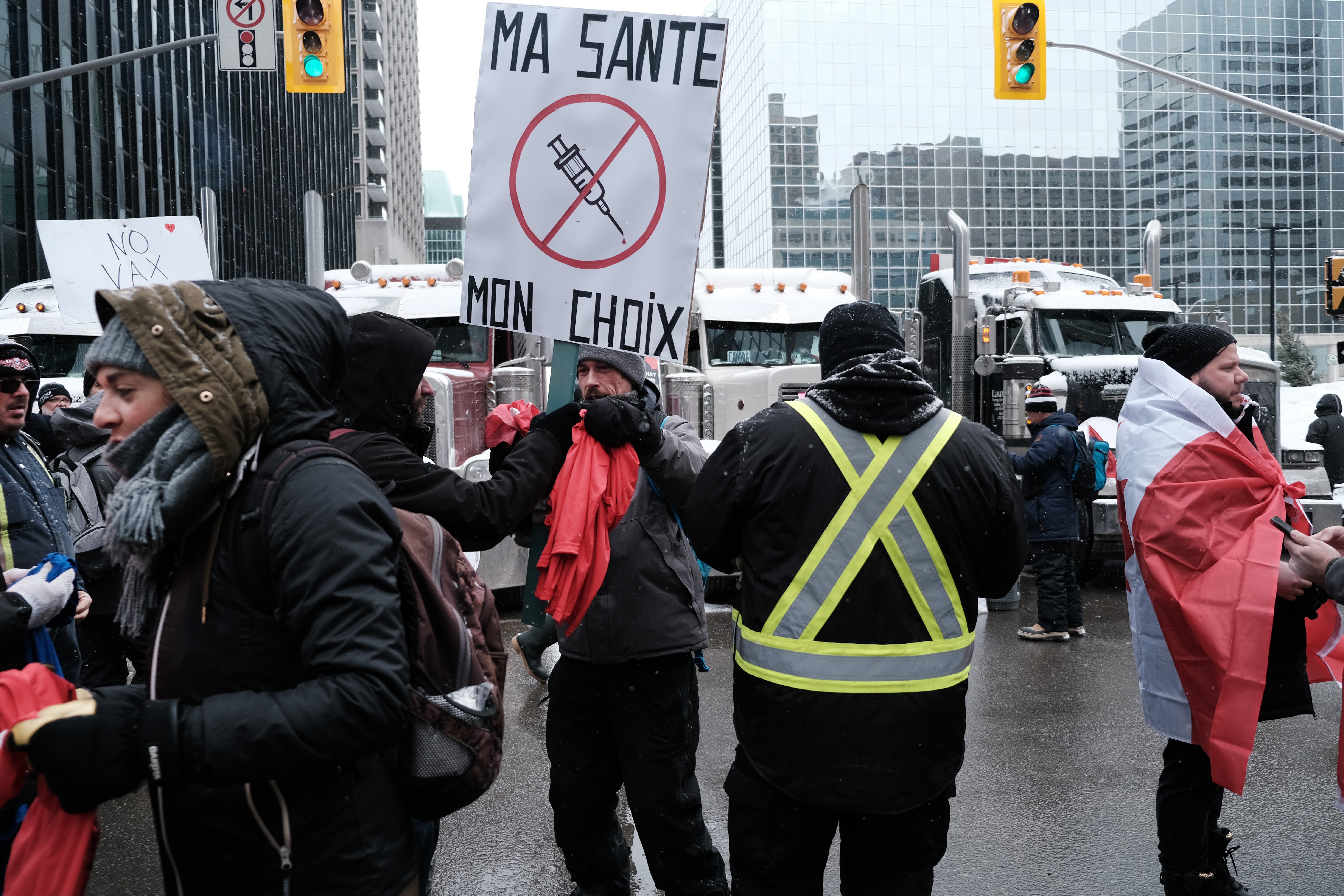 People gather in a snowstorm to take part in an anti-government and anti-vaccine mandate protest on February 12, 2022 in Ottawa, Ontario, Canada