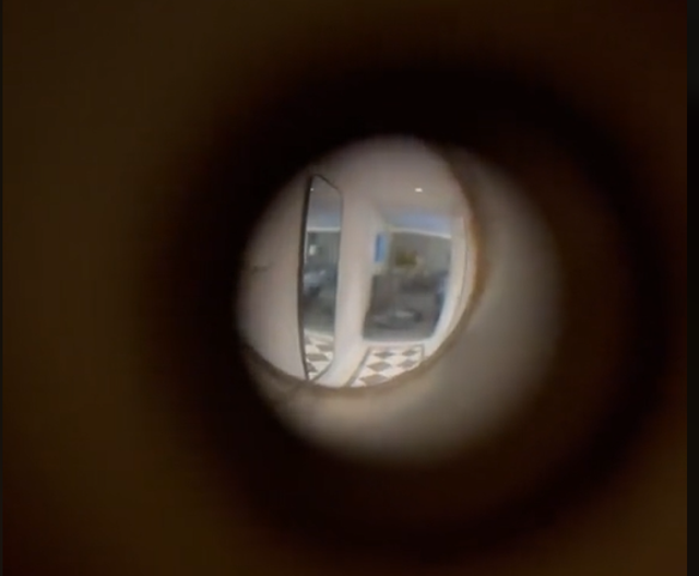 <p>The hotel room peephole in Erin’s video</p>