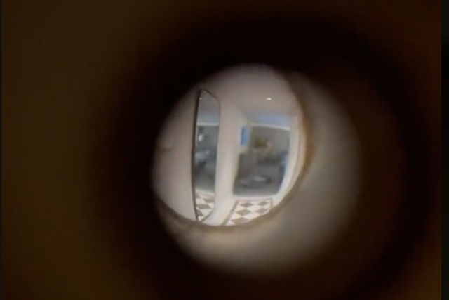 <p>The hotel room peephole in Erin’s video</p>