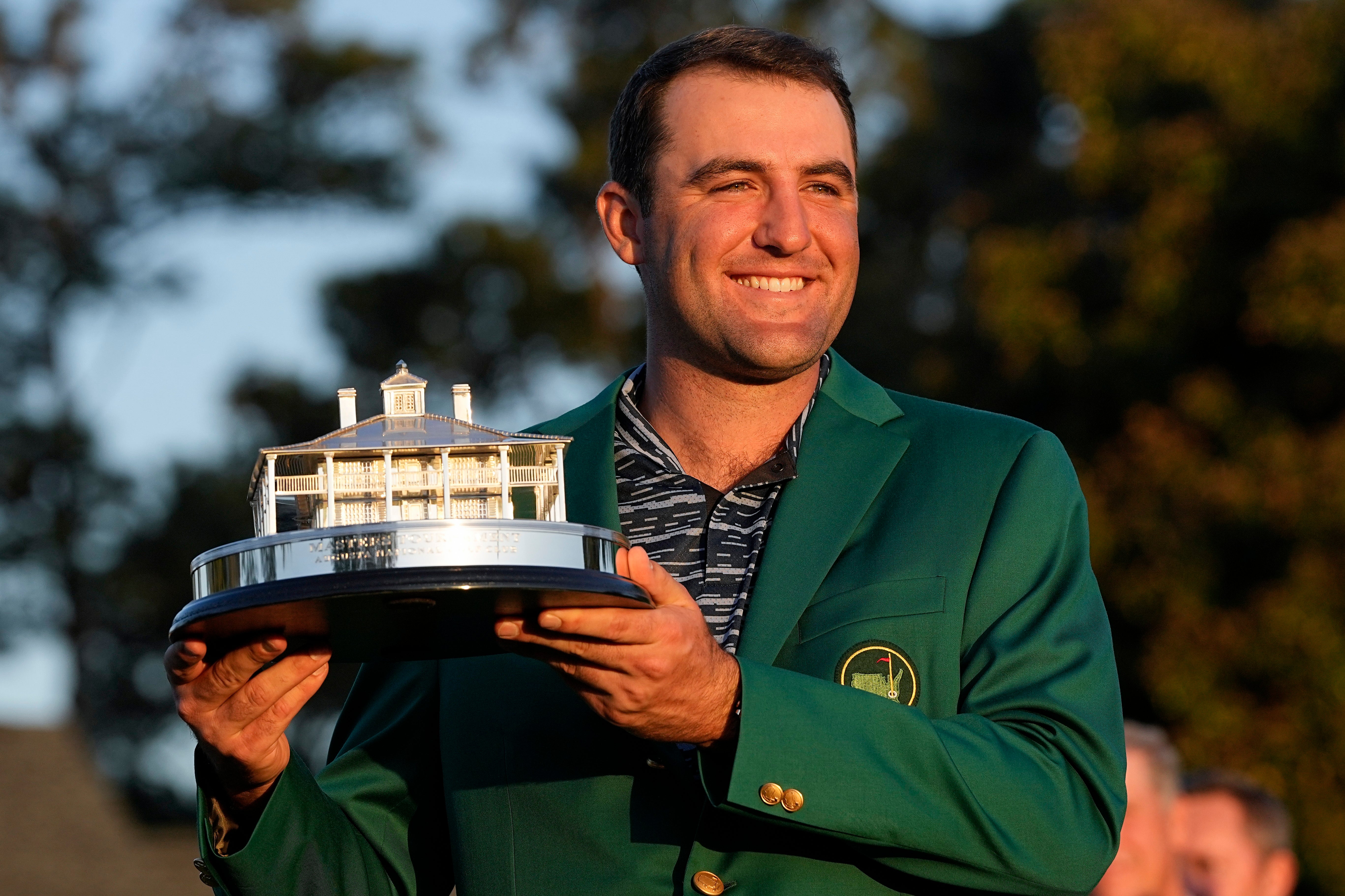 Scottie Scheffler holds the championship trophy after winning the 86th Masters (David J. Phillip/AP)