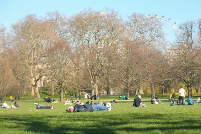 <p>People in St James’ Park, central London, ahead of this week’s warm spell</p>