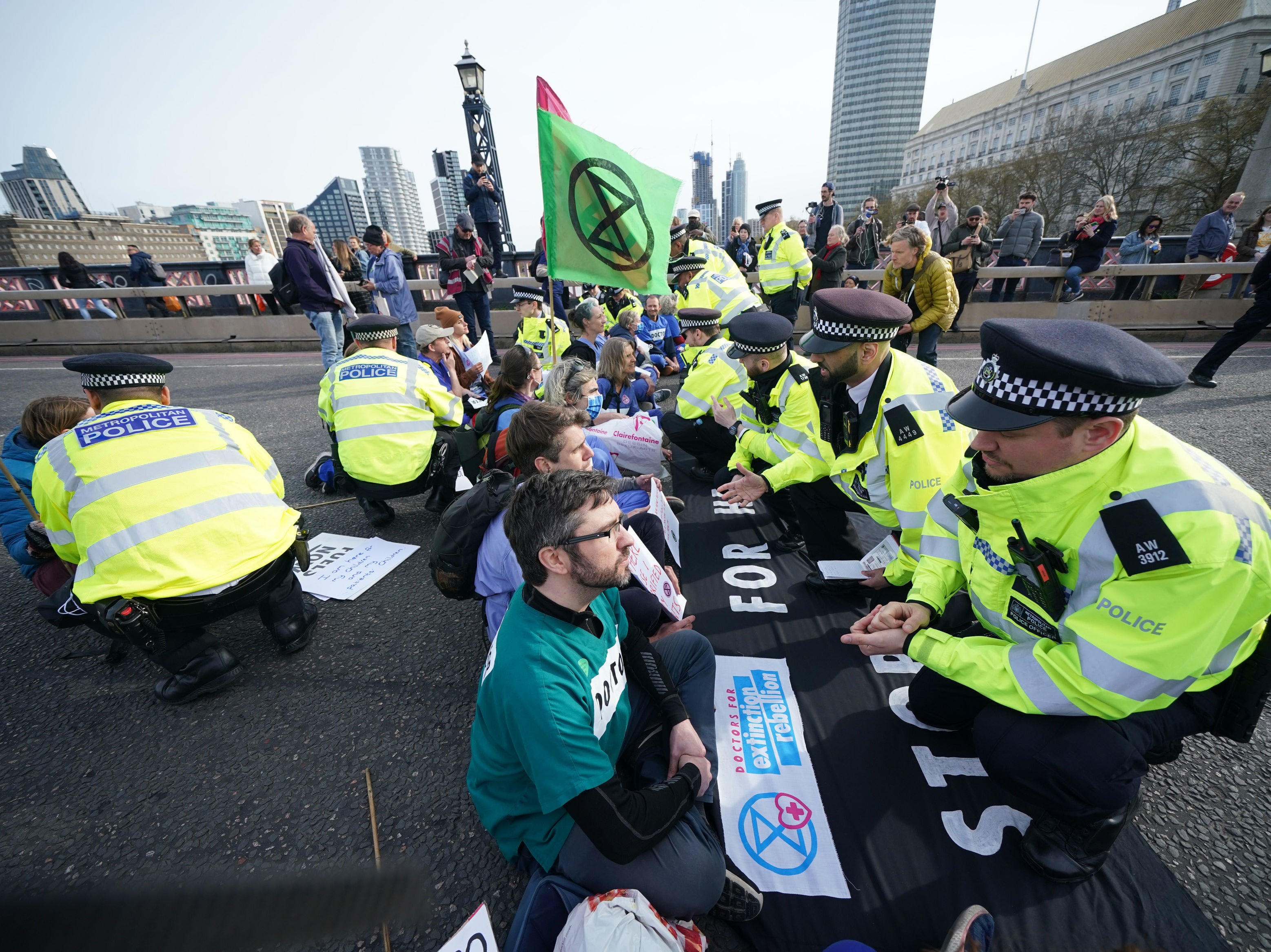 Police talk to protestors taking part in a demonstration on Lambeth Bridge in central London