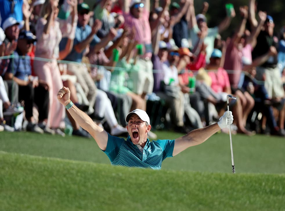 <p>Rory McIlroy celebrates chippig in from the bunker on 18</p>