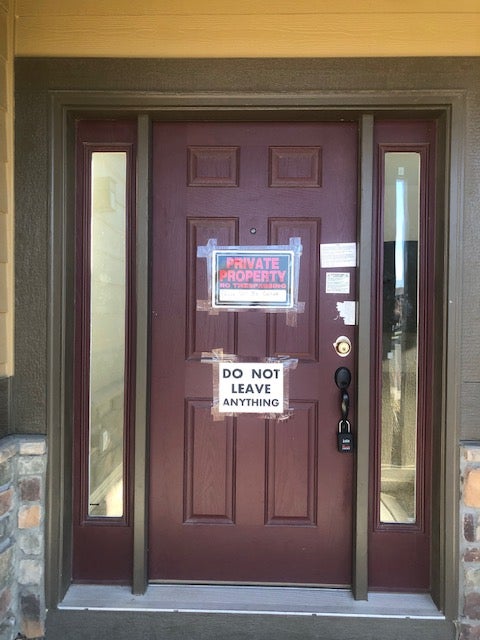 The door to the Watts home in Frederick, Colorado is padlocked and signs warn curious onlookers to stay away from the property