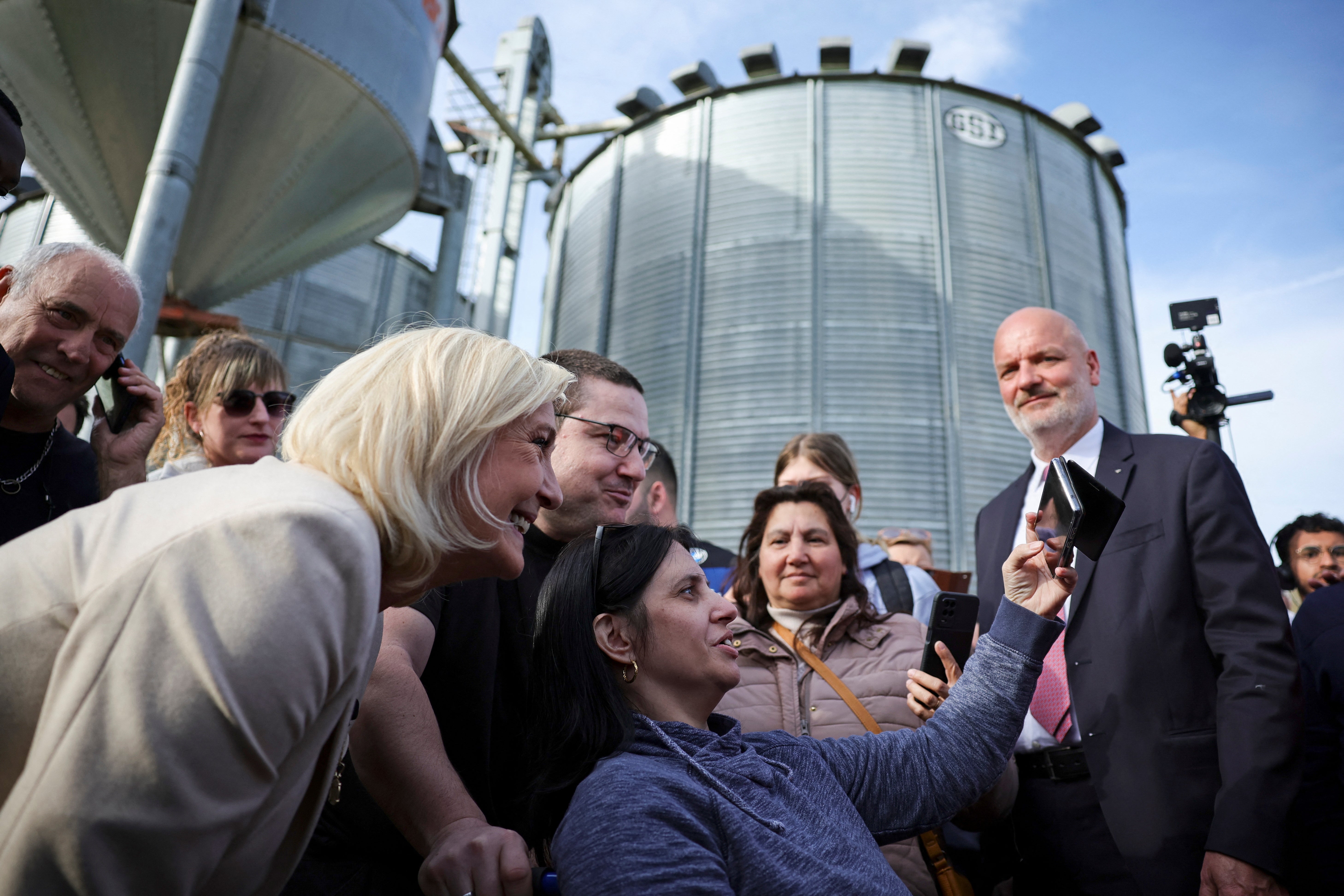 The National Rally leader takes a selfie with supporters