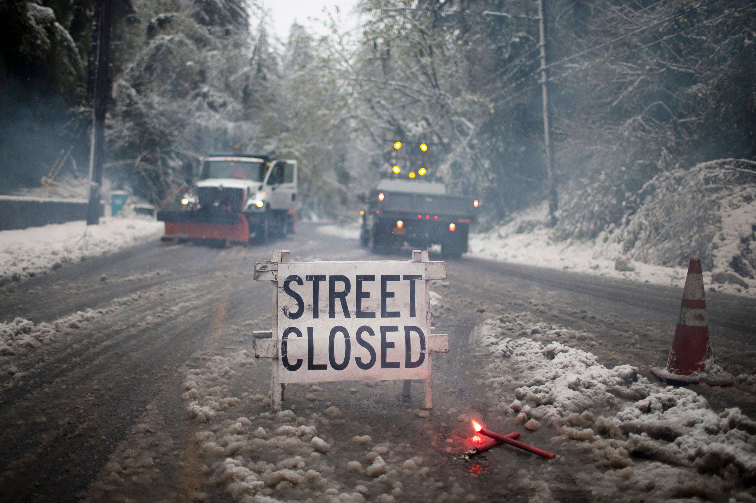 Crews closed W Burnside Rd. at SW Tichner Dr. as several inches of snow fell in the Portland area on, Monday, April 11, 2022. Portland received the first measurable snowfall in April in recorded history on Monday. (Dave Killen/The Oregonian via AP)