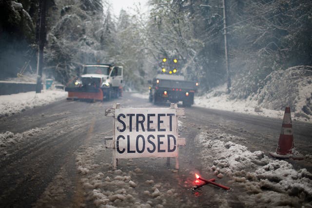<p>Crews closed W Burnside Rd. at SW Tichner Dr. as several inches of snow fell in the Portland area on, Monday, April 11, 2022. Portland received the first measurable snowfall in April in recorded history on Monday. (Dave Killen/The Oregonian via AP)</p>