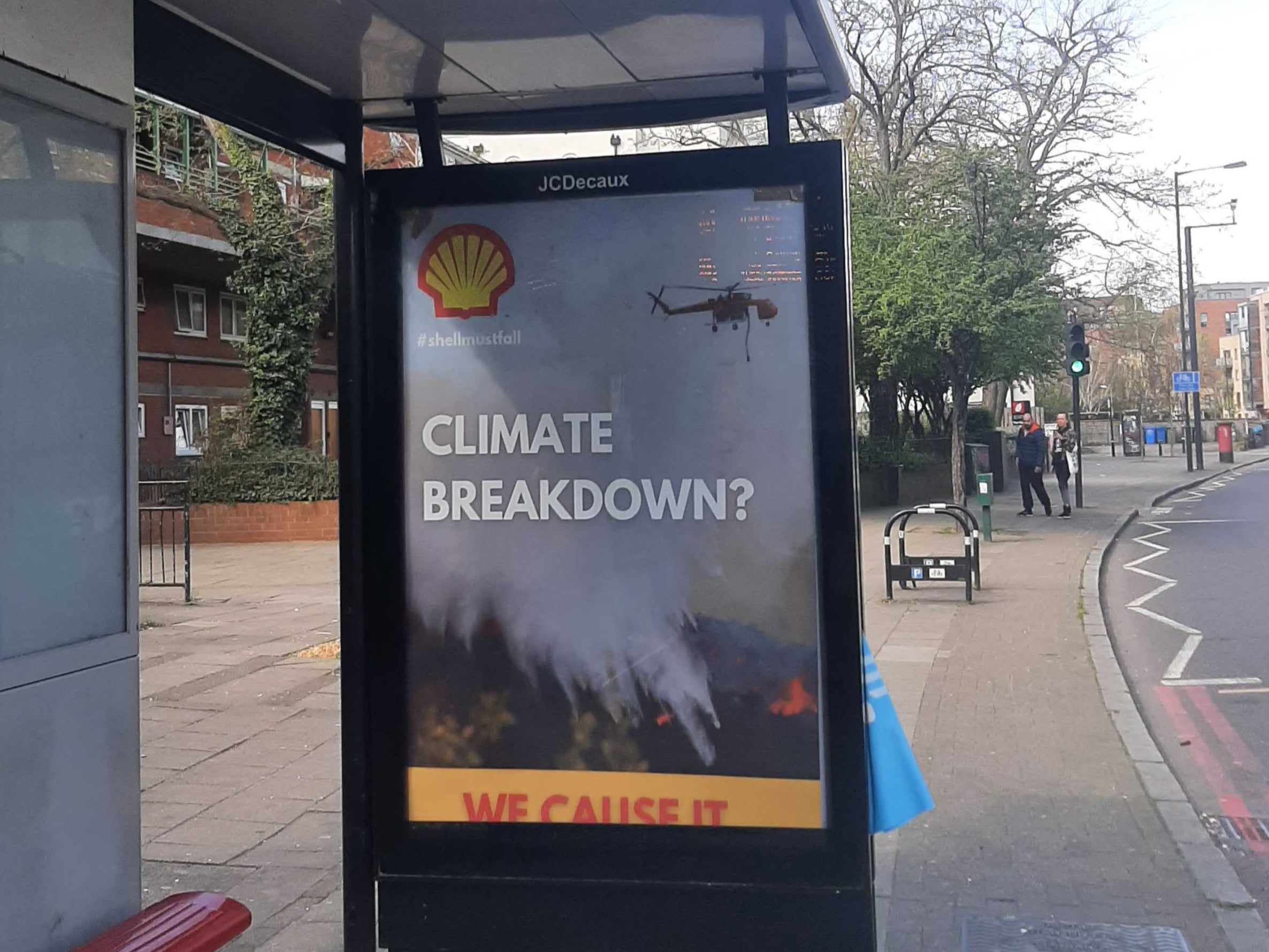 A bus stop in southeast London carries a spoof Shell poster