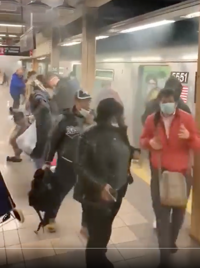 <p>Terrified commuters flee from a smoke-filled carriage after the Brooklyn subway attack on Tuesday morning</p>