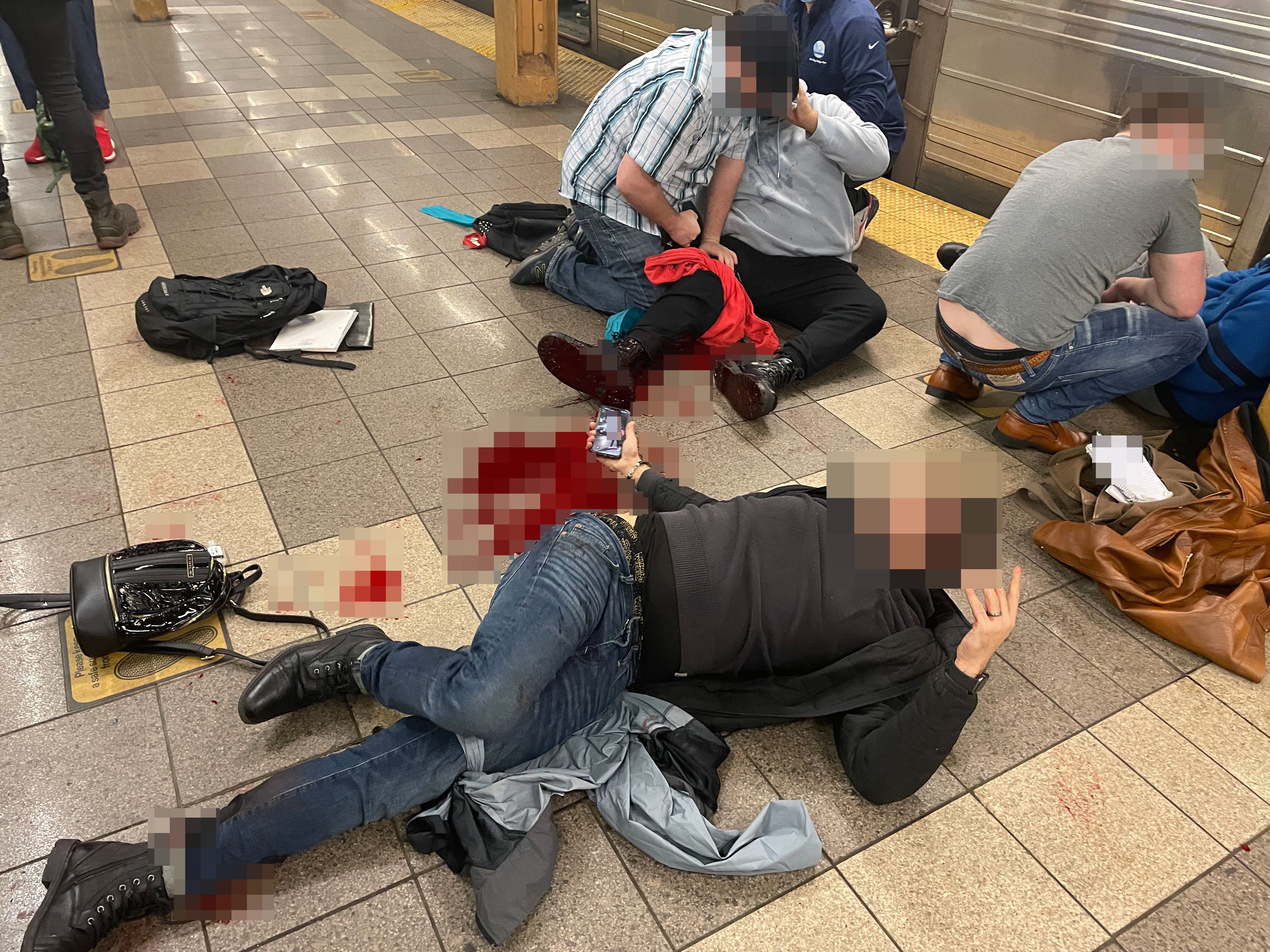 Victims lay on the ground after a shooting at Brooklyn’s 36th Street subway station on 12 April