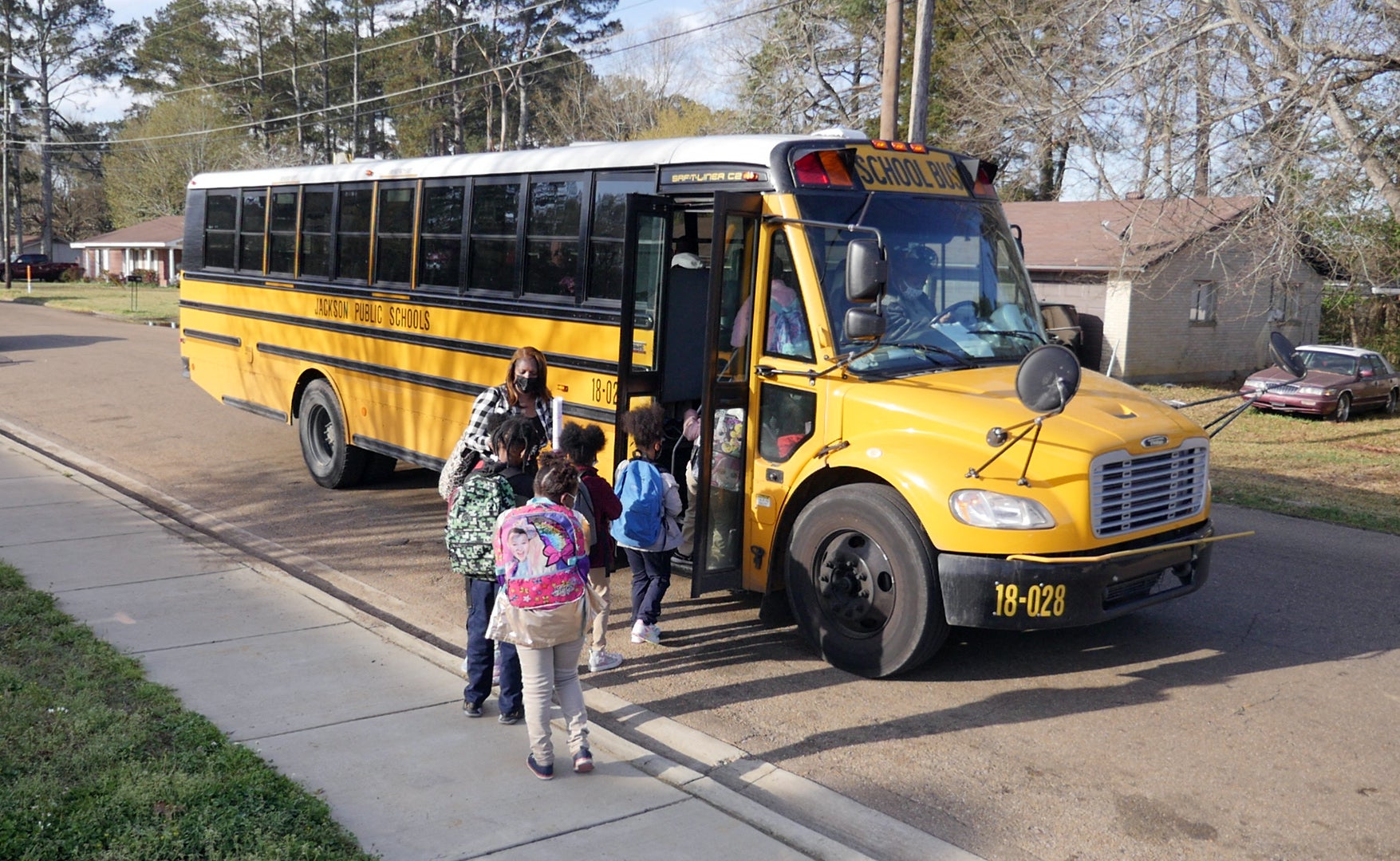 Children board a school bus in Jackson, Mississippi on 24 March 2022. A Florida school bus driver has been terminated after leaving a 15-year-old four miles from their home stop