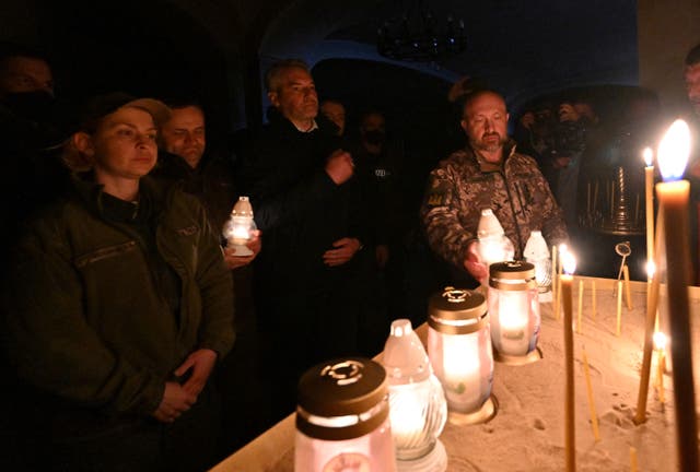 <p>Austrian Chancellor Karl Nehammer (c) joined a vigil for those killed in Bucha</p>