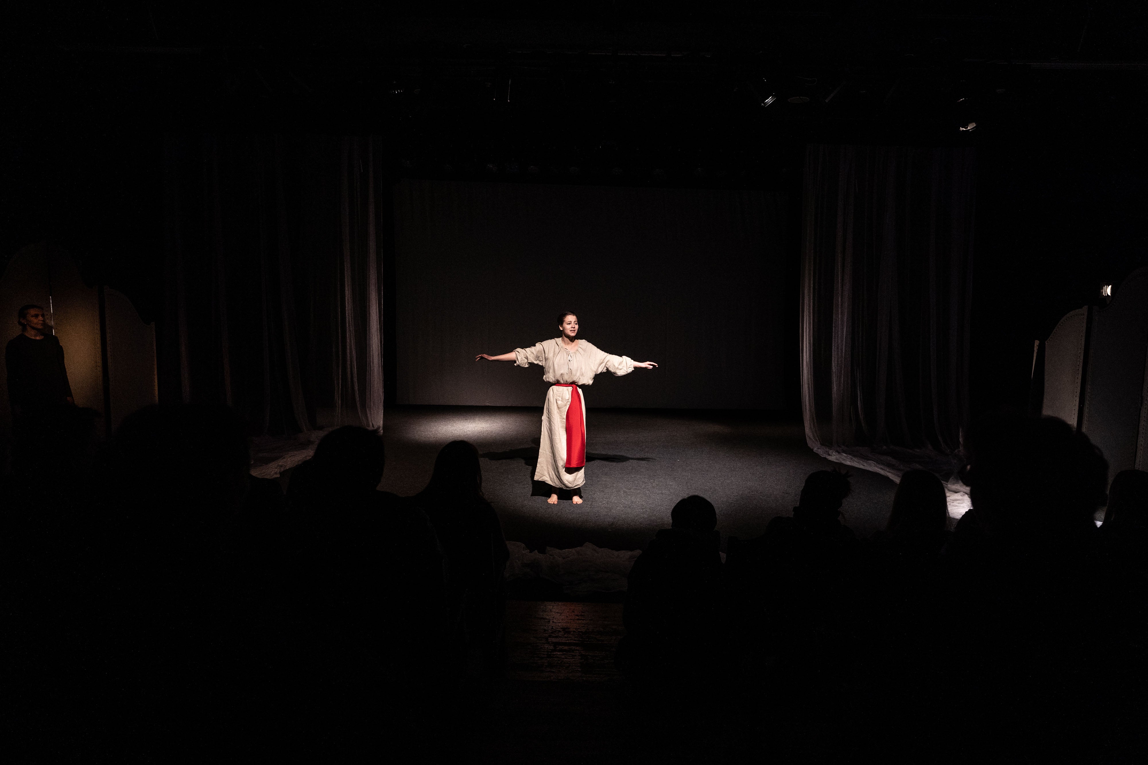 An actress holds forth on the stage of the Lesya Ukrainka National Academic Theater in Kyiv during its first performances since Russia invaded Ukraine