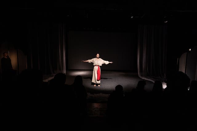 <p>An actress holds forth on the stage of the Lesya Ukrainka National Academic Theater in Kyiv during its first performances since Russia invaded Ukraine</p>