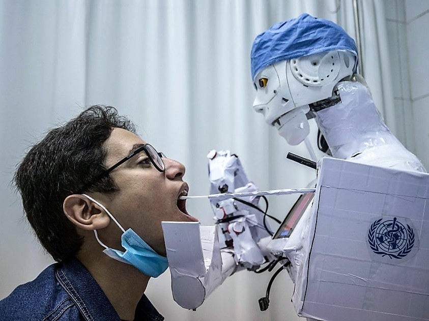 A remote-controlled robot prototype extracts a throat swab sample, as part of a project to assist physicians in running tests on suspected Covid-19 patients n Egypt’s Nile delta city of Tanta, on 20 March, 2021