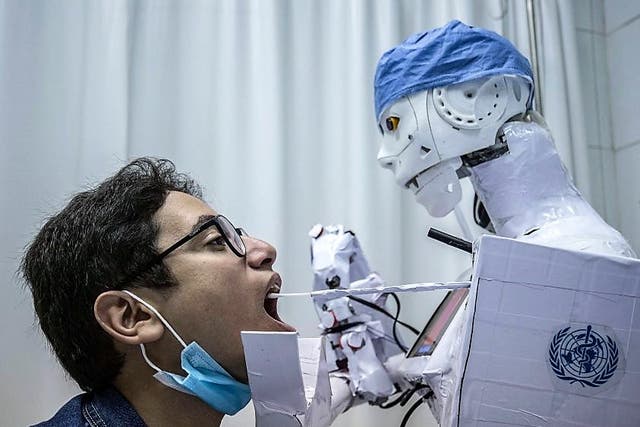 <p>A remote-controlled robot prototype extracts a throat swab sample, as part of a project to assist physicians in running tests on suspected Covid-19 patients n Egypt’s Nile delta city of Tanta, on 20 March, 2021</p>
