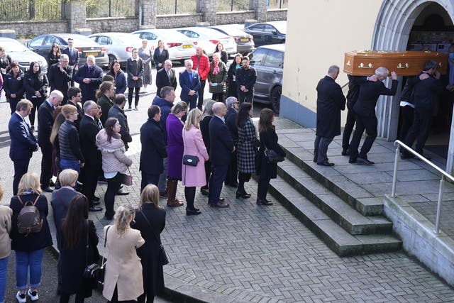 Pallbearers carry the coffin of Jody Keenan into the Church of the Assumption, Drumalane, for the funeral of the 39-year-old teaching assistant who died while waiting for an ambulance crew to arrive in Newry (Brian Lawless/PA)