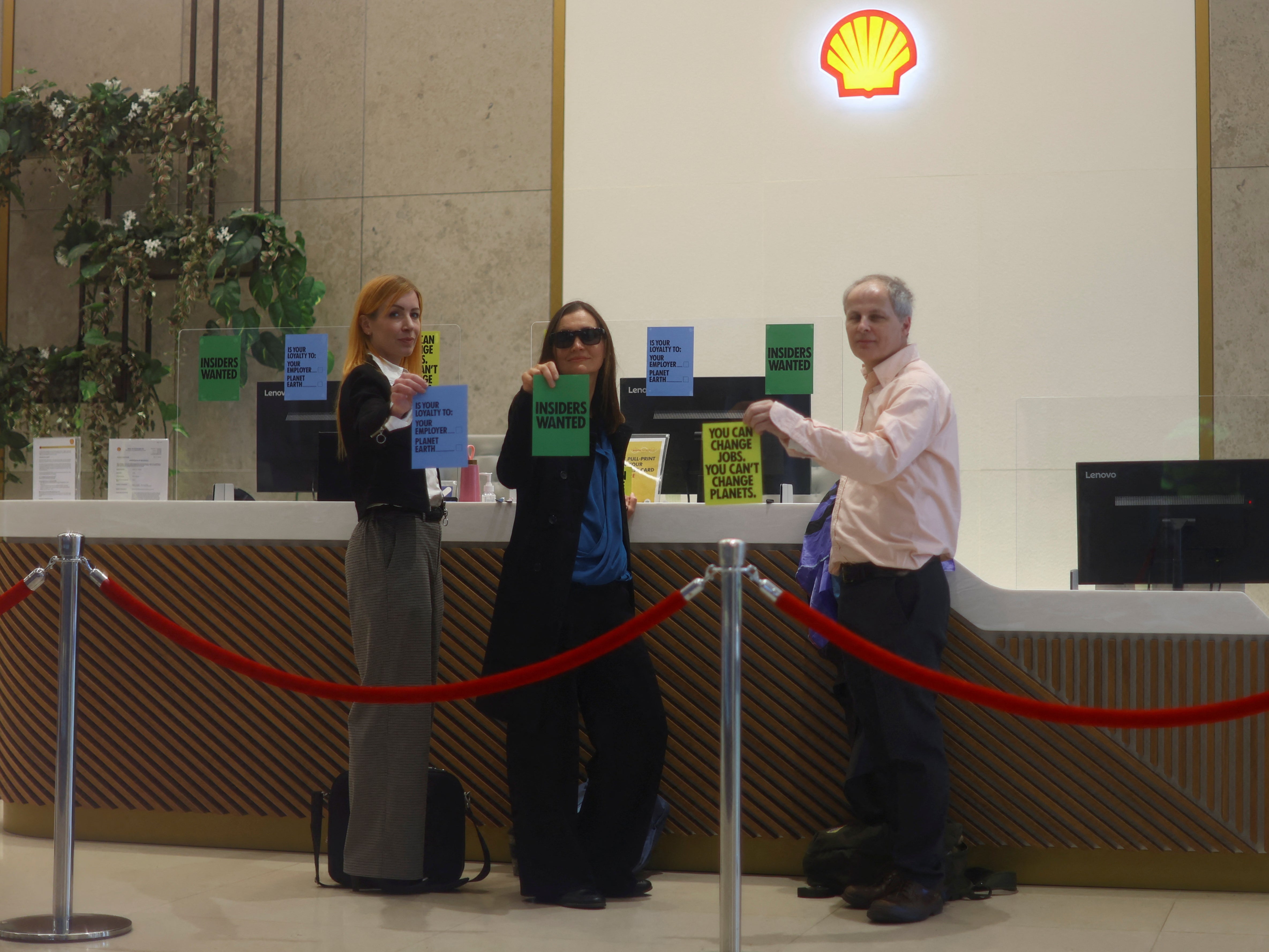 Activists from Extinction Rebellion glue themselves to the reception desk at Shell's headquarters