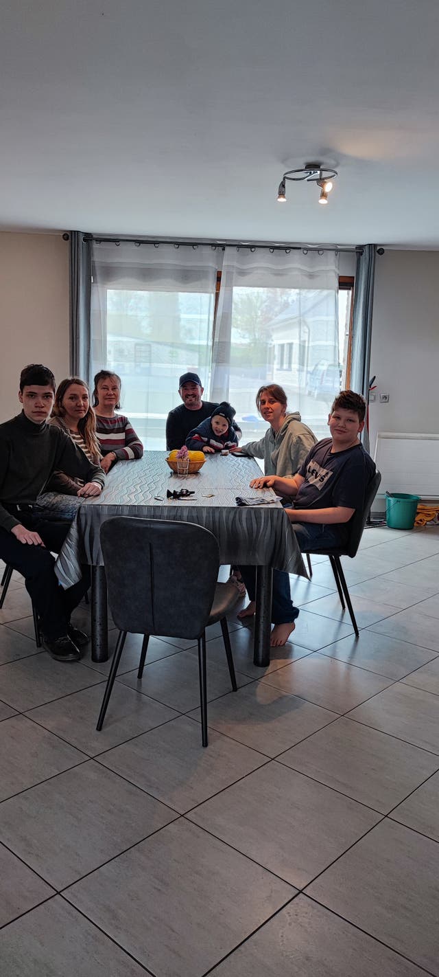 Scout leader Adam Hale-Sutton (in centre with baseball cap) with six Ukrainian refugees who he is helping travel to the UK under the Ukraine Sponsorship Scheme (Adam Hale-Sutton/PA)