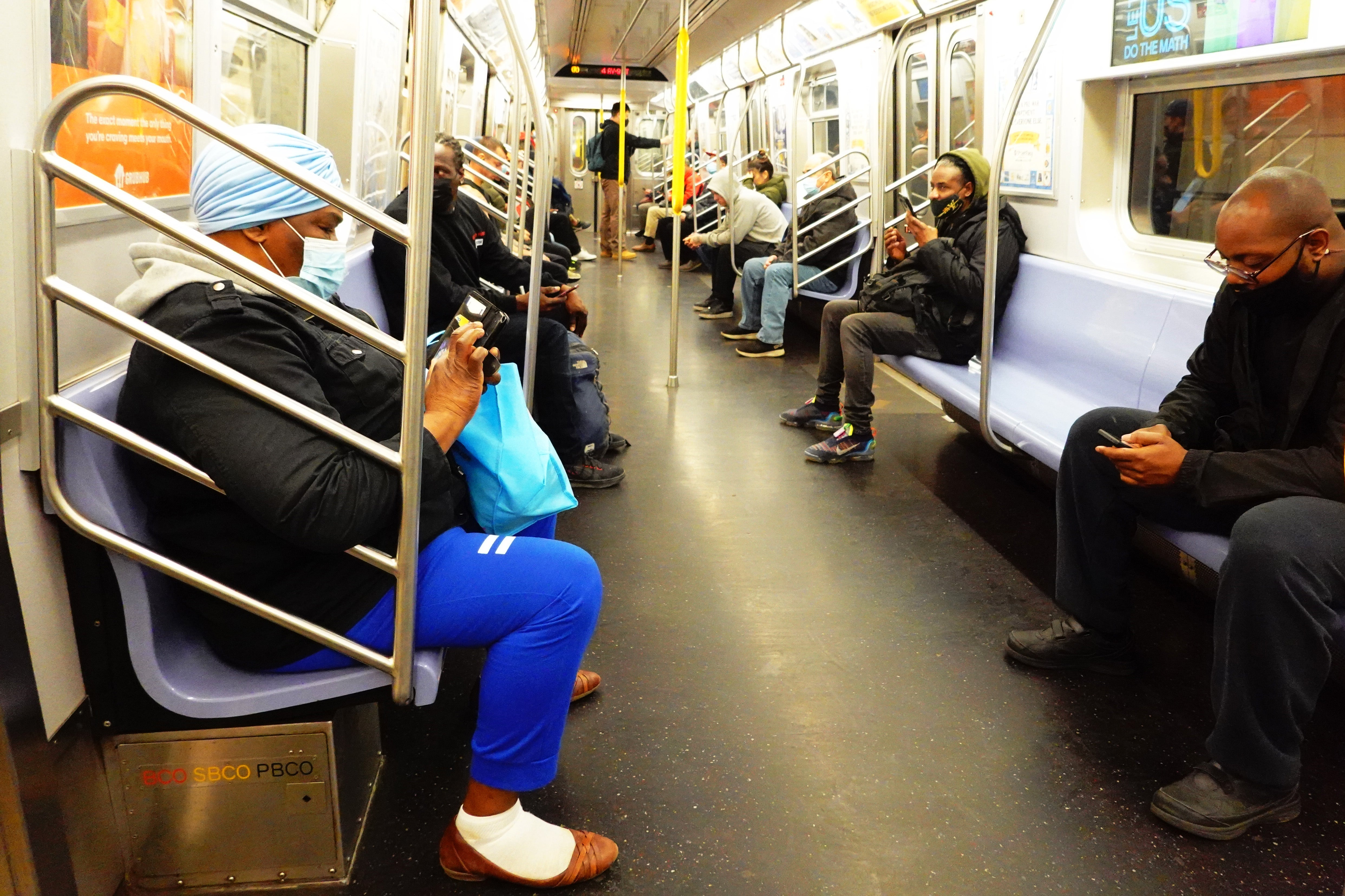 People ride the R train during the morning commute on 13 April in Sunset Park - one day after subway attack