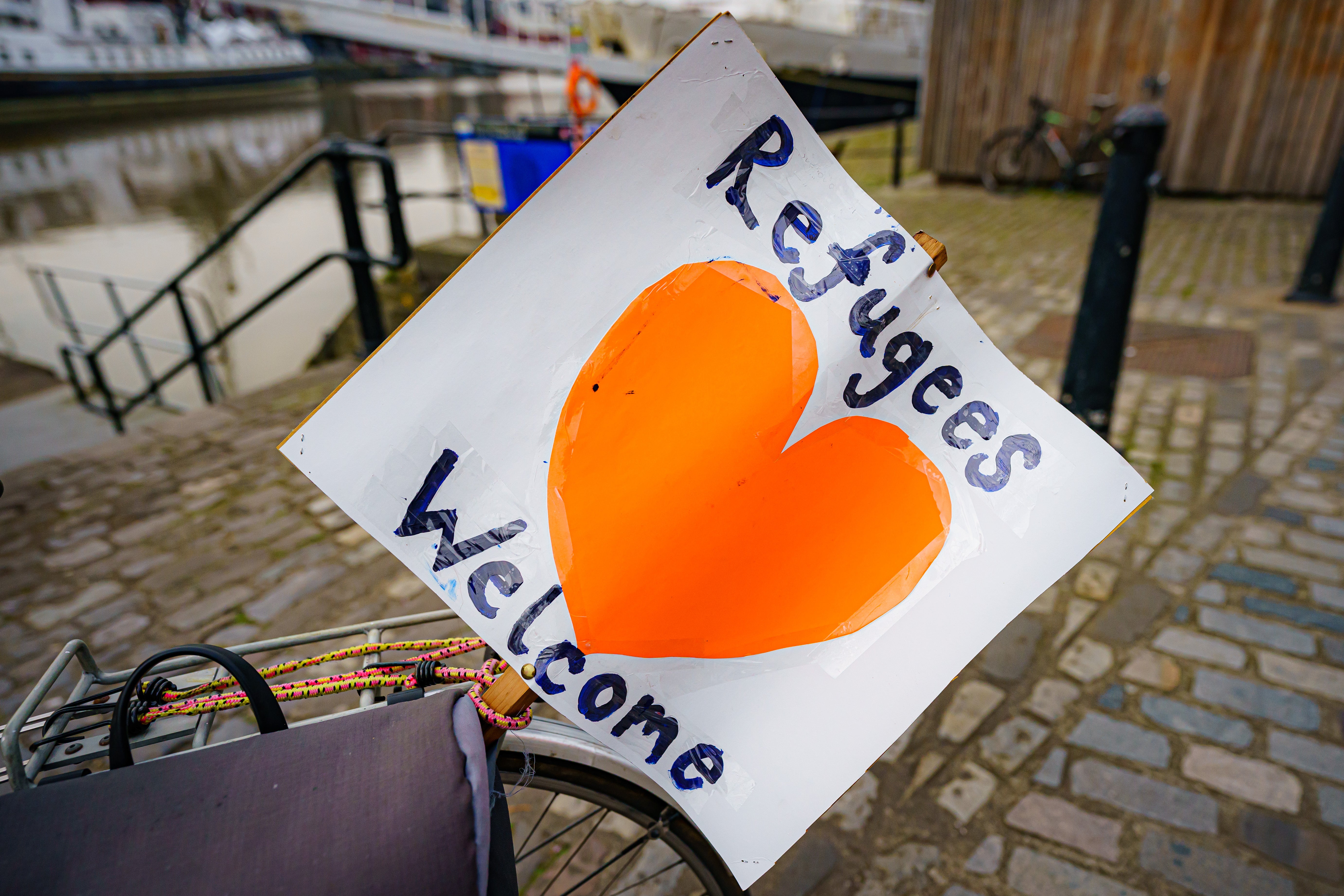 A ‘refugees welcome’ banner is attached to a bicycle in Bristol (Ben Birchall/PA)