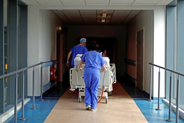 Medical staff transfer a patient through a corridor at The Royal Blackburn Teaching Hospital in East Lancashire (PA)