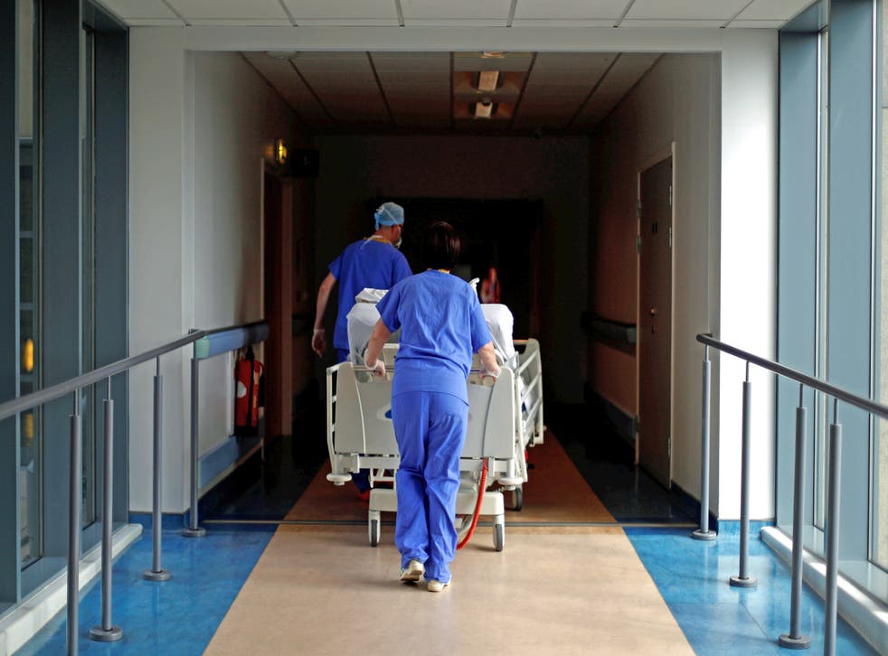 Medical staff transfer a patient through a corridor at The Royal Blackburn Teaching Hospital in East Lancashire (PA)