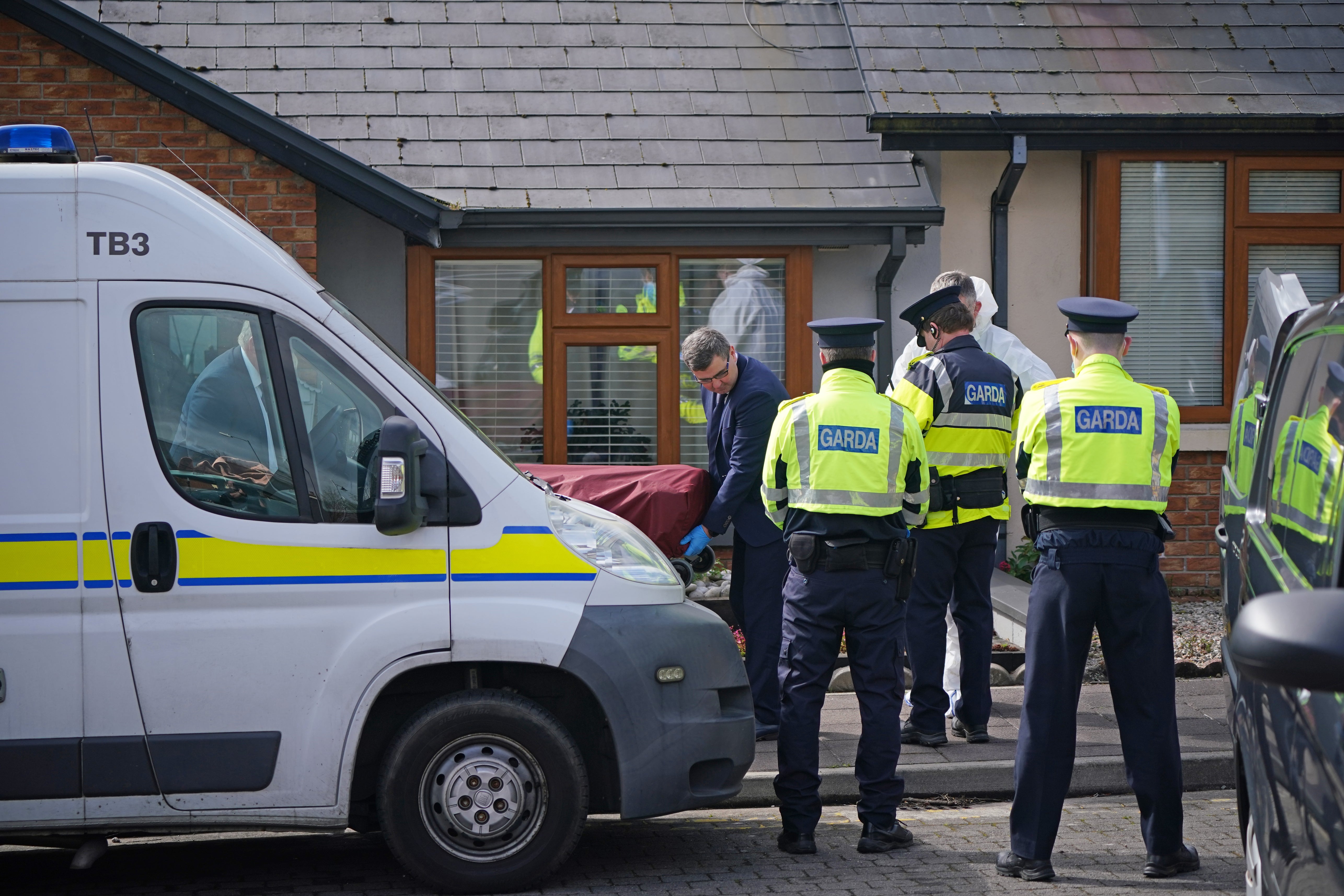 Gardai remove the body of Michael Snee from his home in Sligo (Niall Carson/PA)
