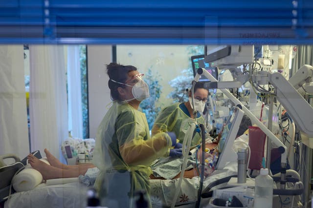 <p>Representative: Health workers monitor a patient in an intensive care unit in Switzerland </p>