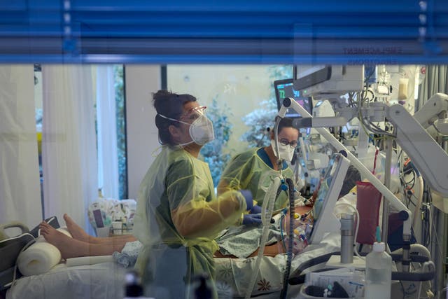 <p>Representative: Health workers monitor a patient in an intensive care unit in Switzerland </p>