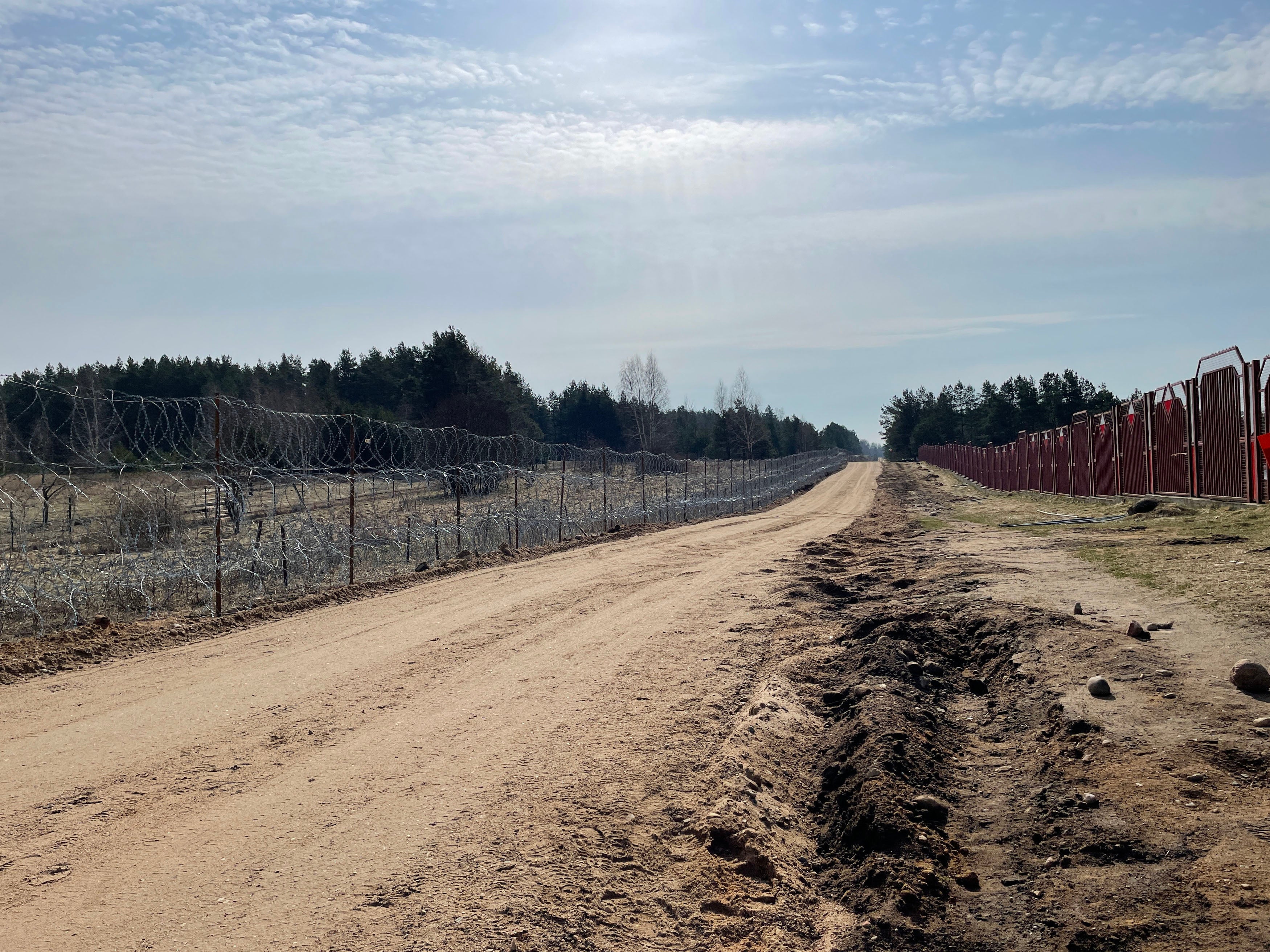 Polish security officials strung razor wire to stop immigrants crossing from Belarus and are now working on a more permanent steel wall
